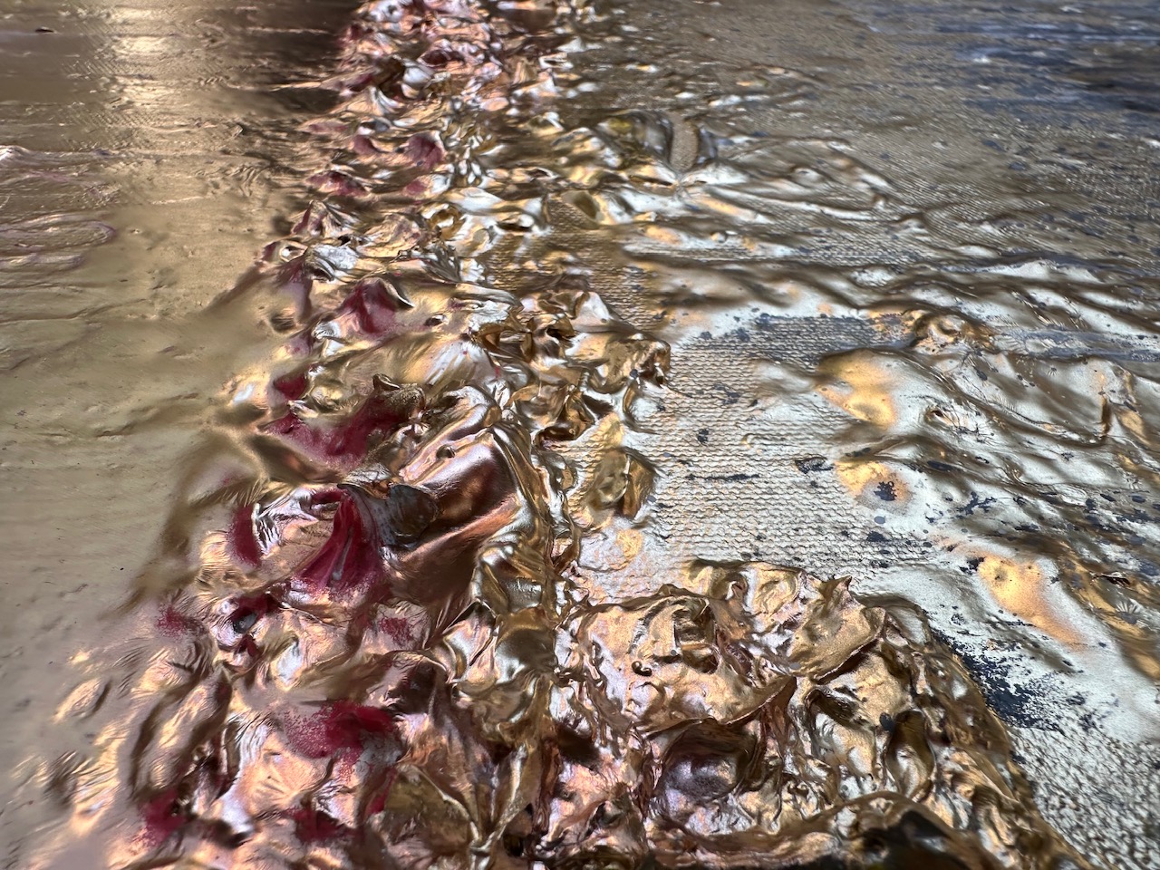 Close-up of shell-like sculpted texture along a painted shoreline
