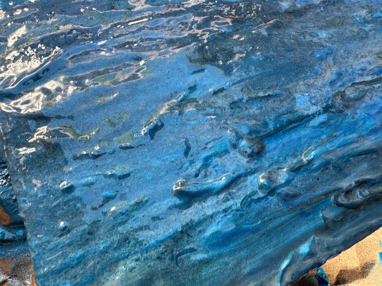 Close-up of thick blue impasto texture in one of Danielle Eze's paintings