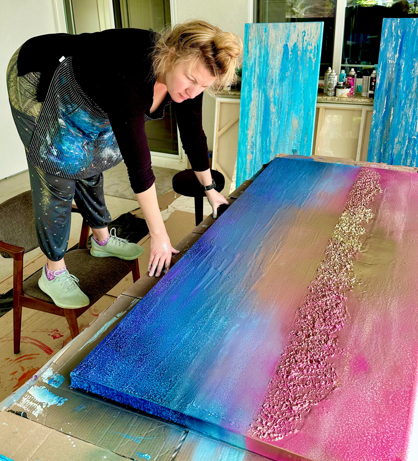 Danielle Eze painting in her studio